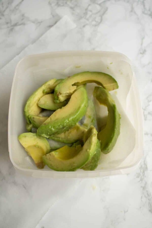 Avocado slices in a freezer box