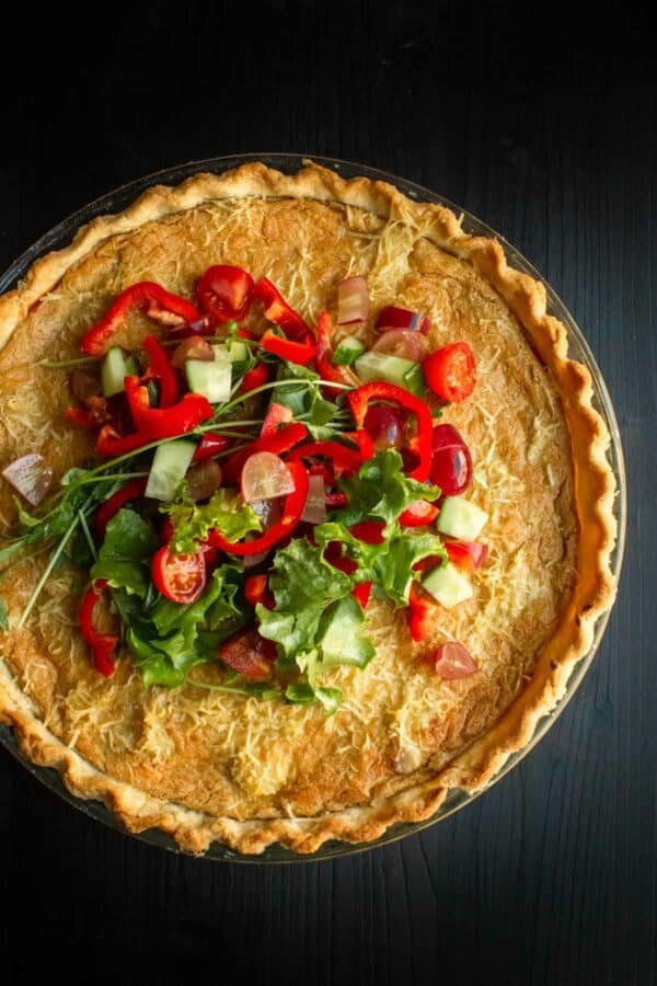 Vegan ham and cheese pie with a garnish of salad